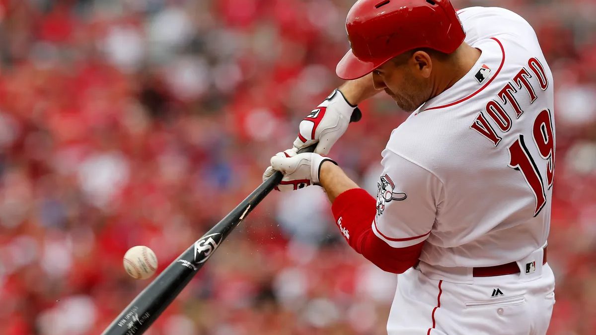 Joey Votto swings at a pitch while batting for the Cincinnati Reds